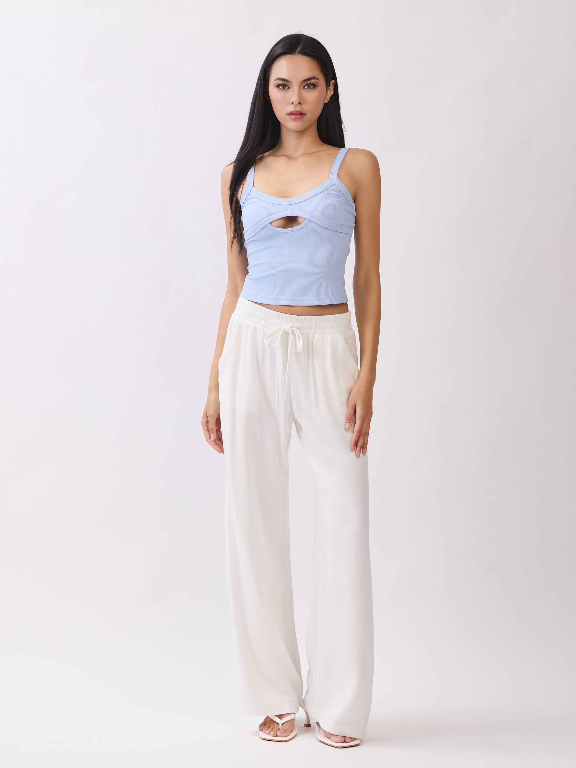 Model wearing BTTRMMT Ivory Yuna Soft Wide Leg Pants with elastic drawstring waist and flowy fit, paired with a light blue tank.