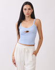 Model wearing BTTRMMT light blue cutout tank top with scoop neckline, paired with white drawstring pants.