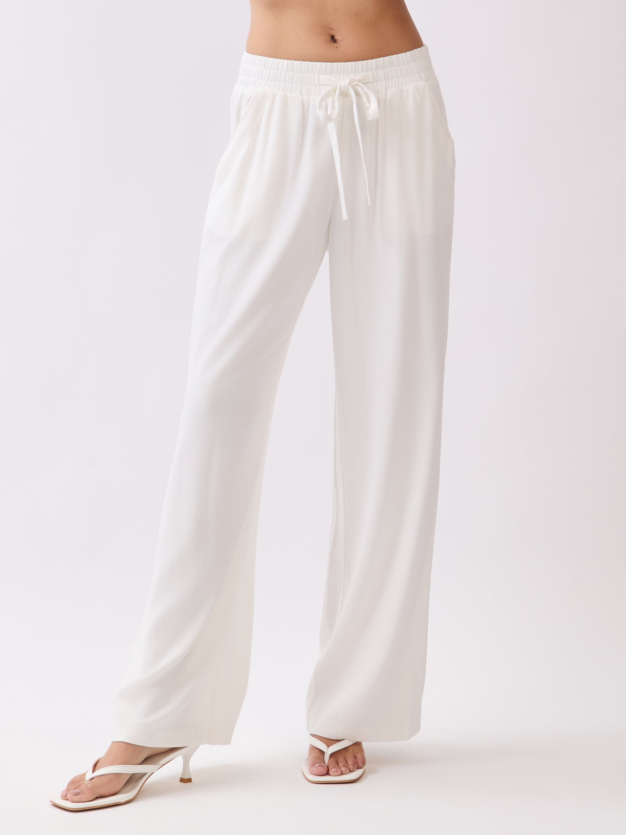 Front view of BTTRMMT Ivory Yuna Soft Wide Leg Pants featuring an elastic waistband, drawstring tie, and flowy lightweight fabric.
