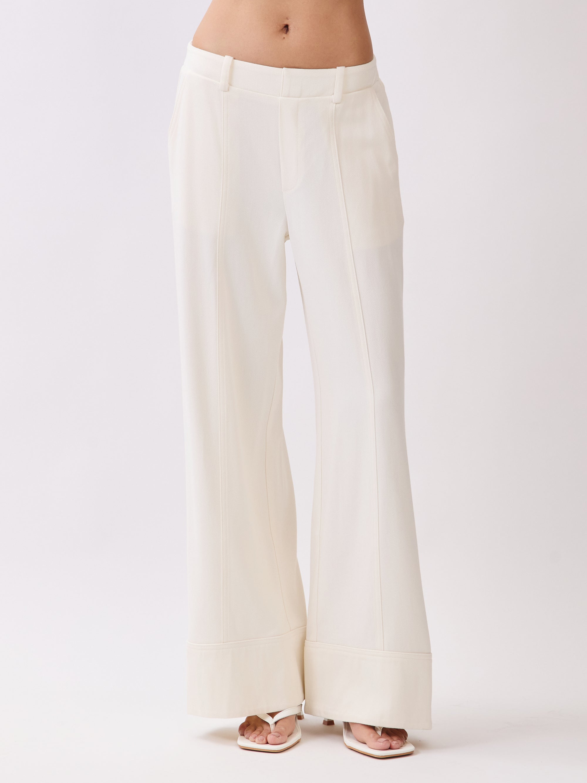 Close-up front view of BTTRMMT Ivory Sophia Pants with a tailored waistband, front seam detailing, and wide-leg hem.