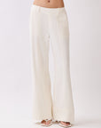 Close-up front view of BTTRMMT Ivory Sophia Pants with a tailored waistband, front seam detailing, and wide-leg hem.
