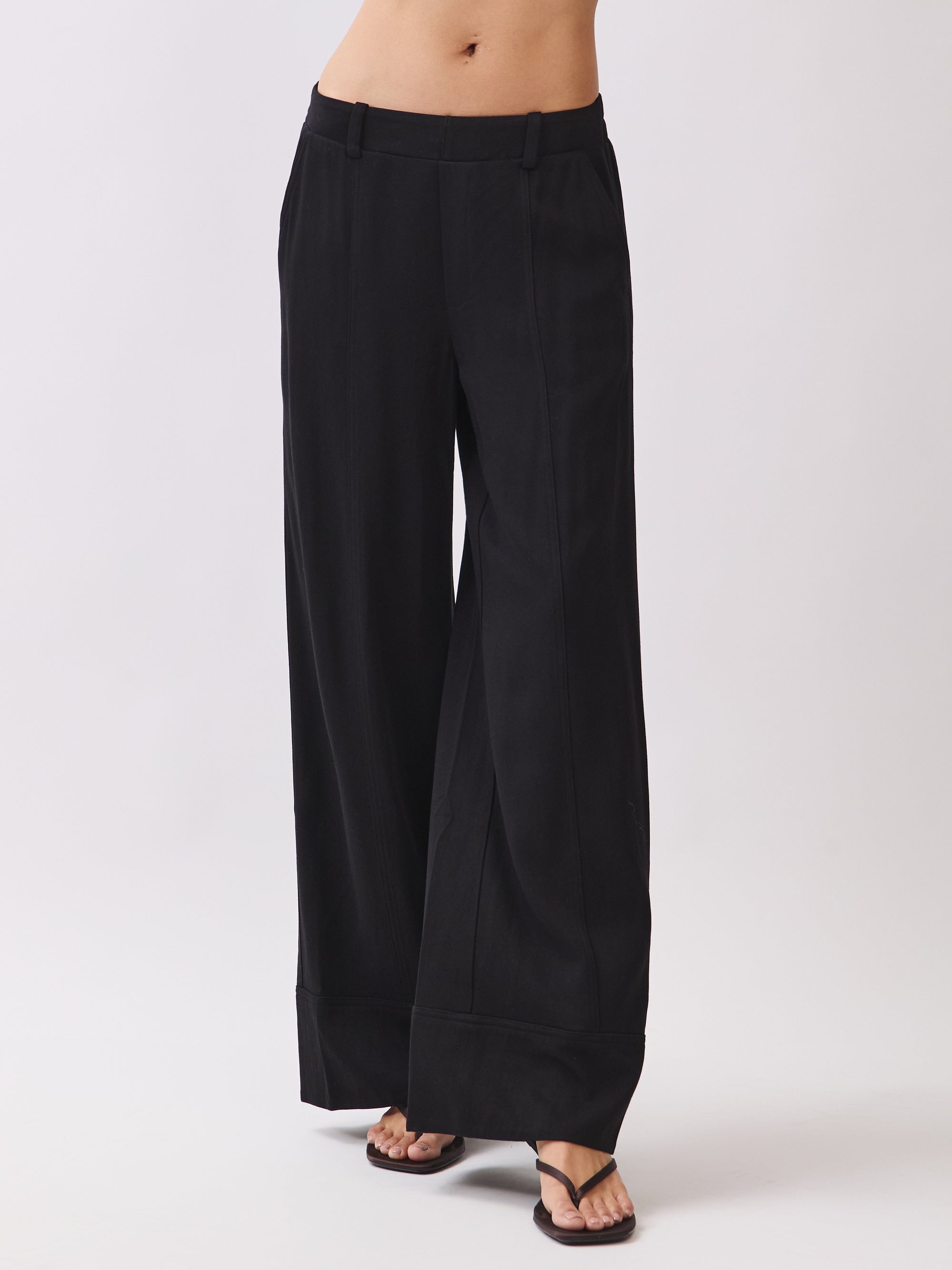 BTTRMMT Black Sophia Pants close-up showing the mid-rise waistband, front seam detailing, and soft wide-leg drape.