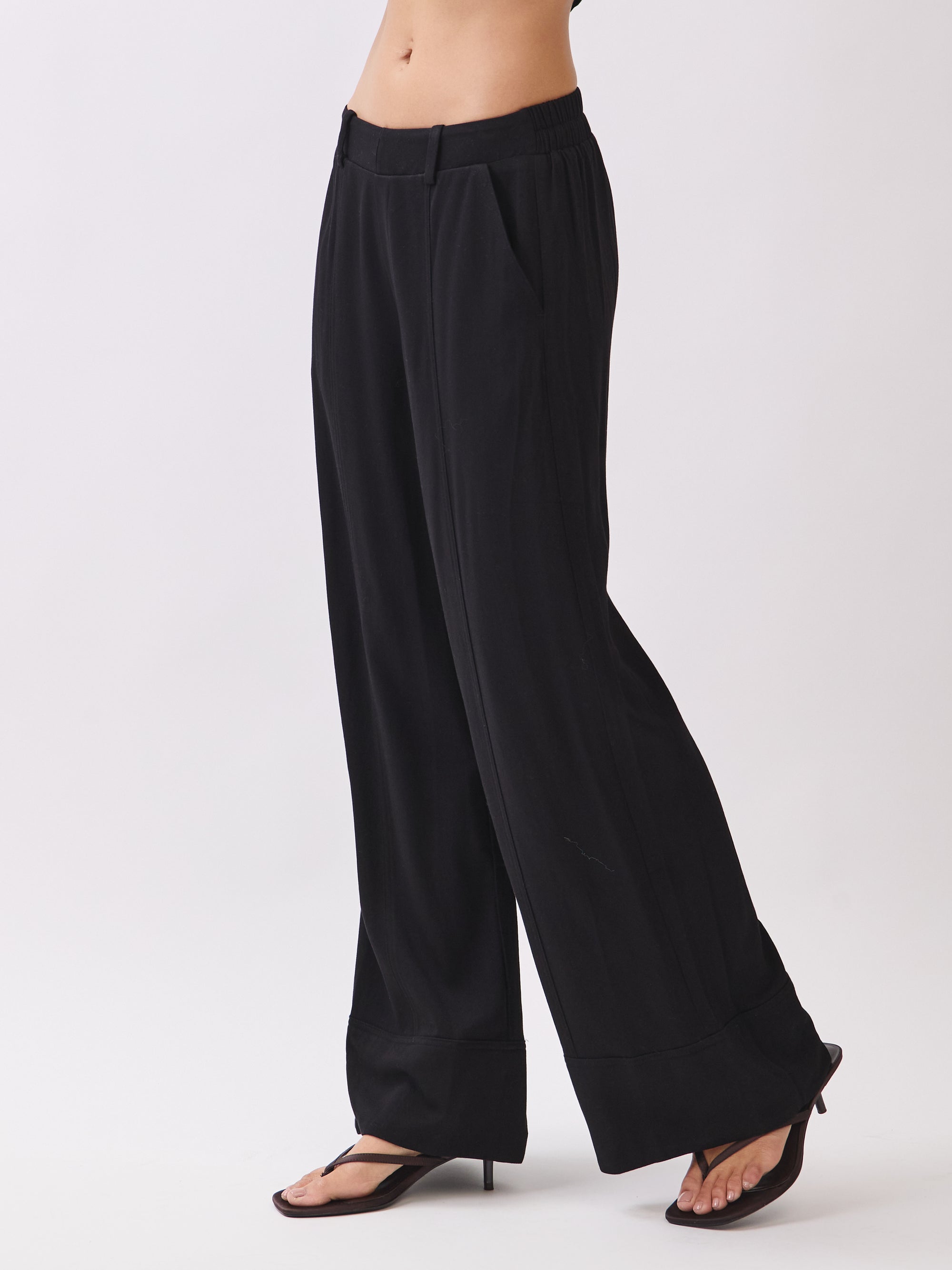 BTTRMMT Black Sophia Pants side view highlighting the wide-leg silhouette, smooth drape, and clean mid-rise waistband.