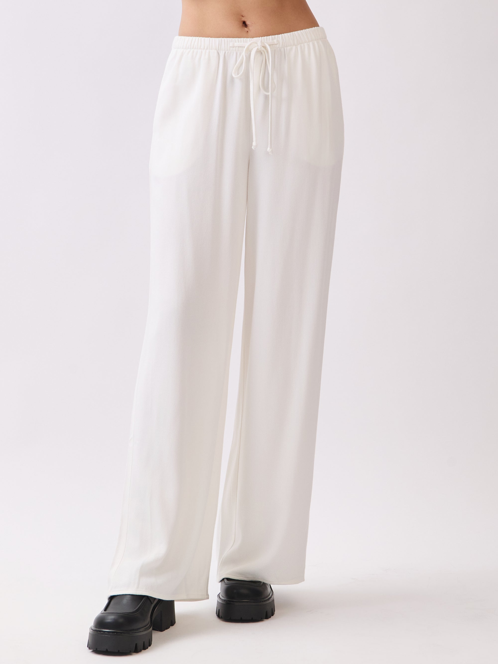 Front view of BTTRMMT Ivory Calia Pants featuring a relaxed wide-leg fit and soft draped silhouette.