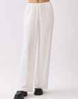 Front view of BTTRMMT Ivory Calia Pants featuring a relaxed wide-leg fit and soft draped silhouette.