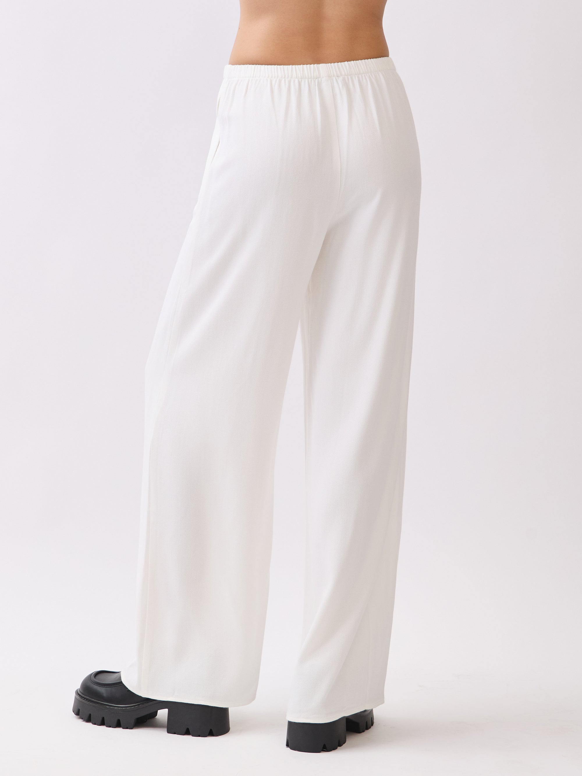 Back view of BTTRMMT Ivory Calia Pants featuring a relaxed wide-leg fit and soft draped silhouette.