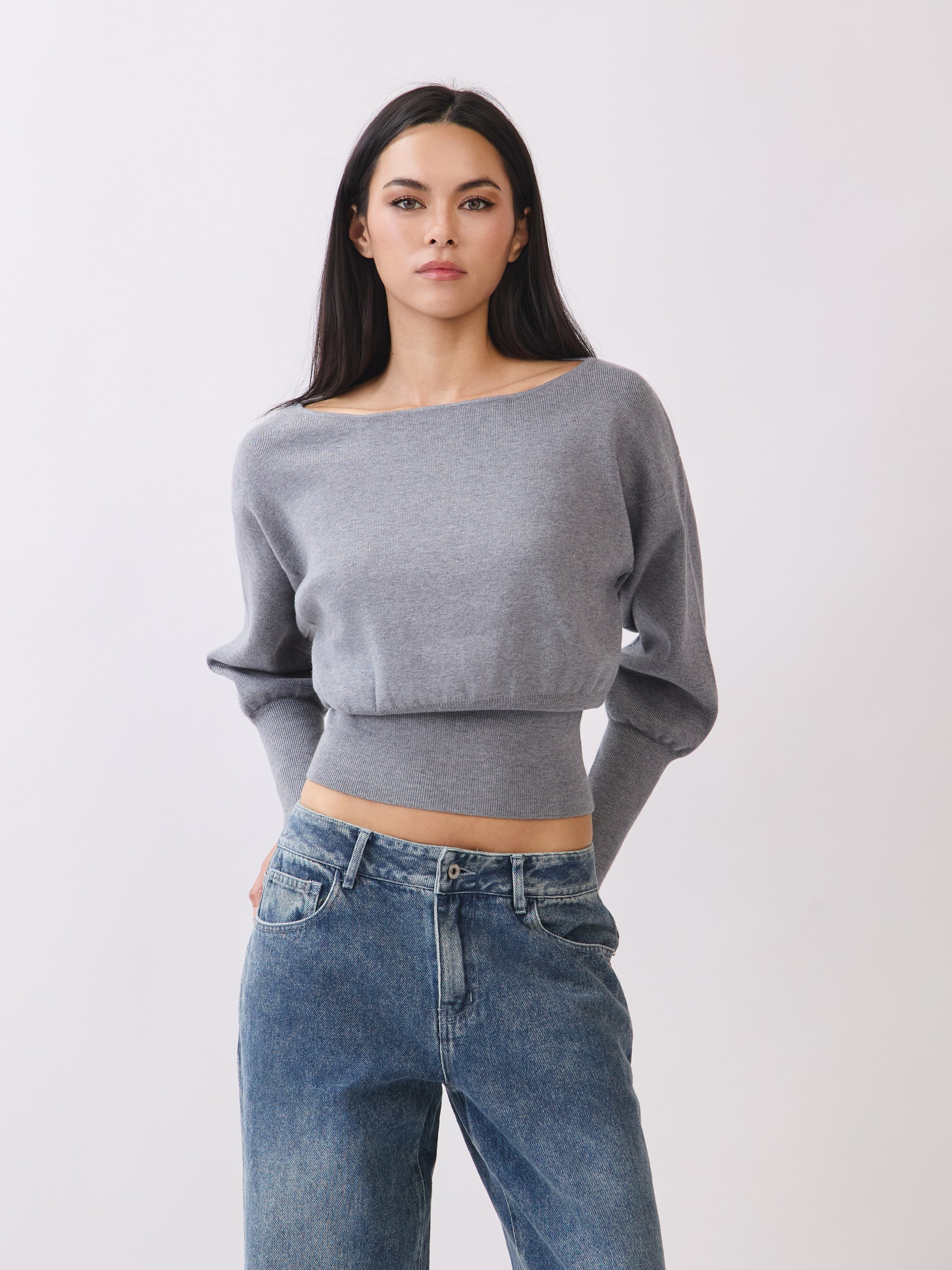 Model wearing BTTRMMT Gray Tessa Boatneck Sweater, ribbed off-shoulder knit with long sleeves.