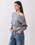 Side view of Model wearing BTTRMMT Gray Tessa Boatneck Sweater, ribbed off-shoulder knit with long sleeves.
