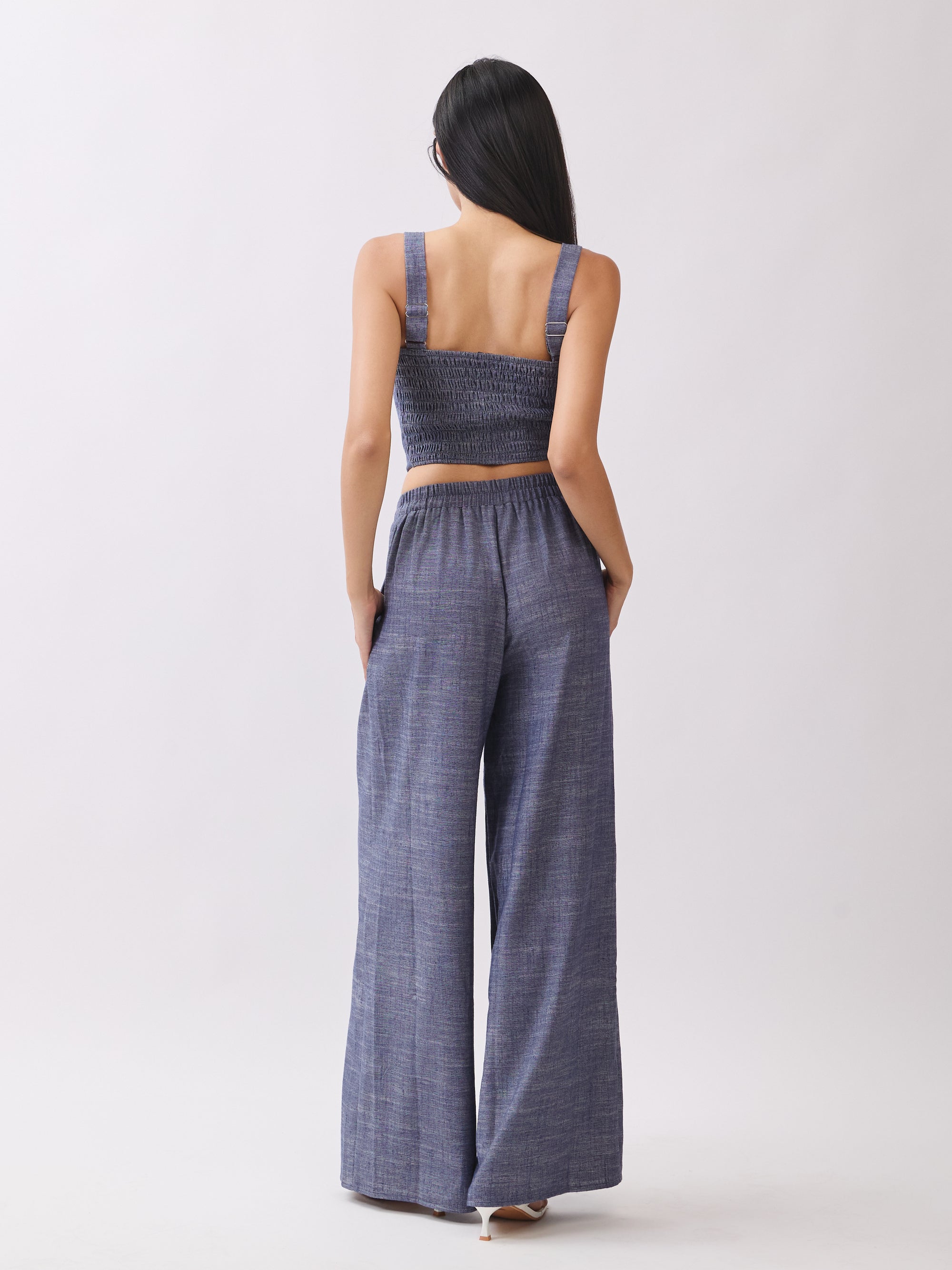 Back view of BTTRMMT Denim Olivyn Set in blue, showing the cropped top and high-waist wide-leg pants in a relaxed denim silhouette.