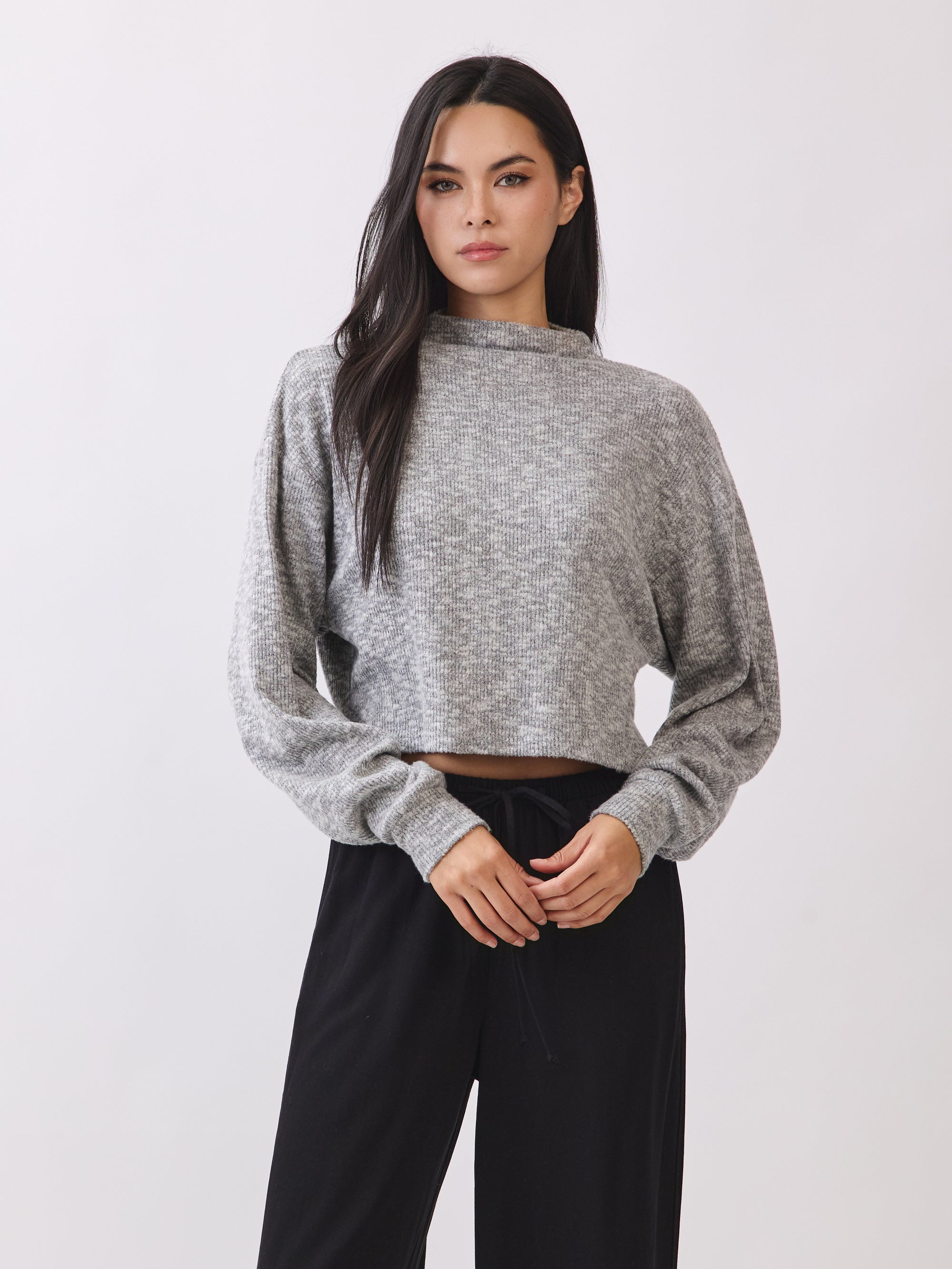 Model wearing the BTTRMMT Elina High Neck Sweater in heather gray, a soft cropped knit with long sleeves and a relaxed fit.