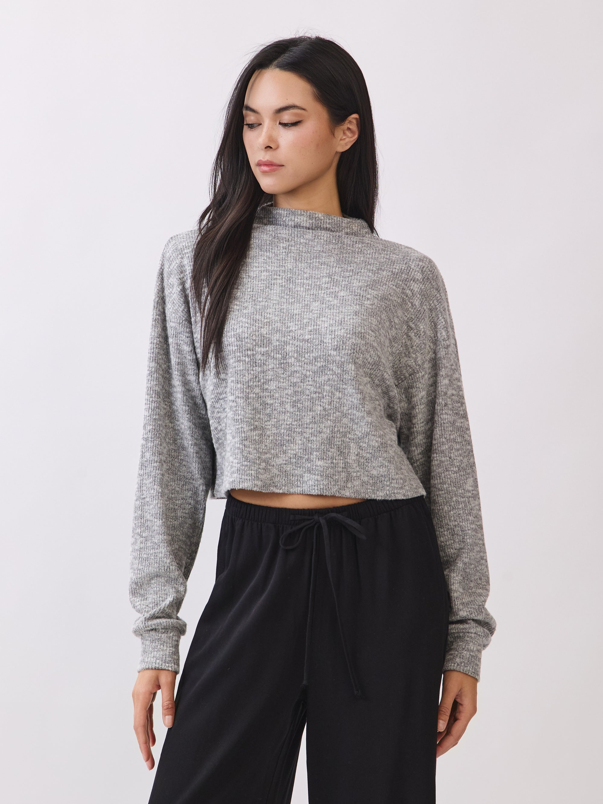 Model wearing the BTTRMMT Elina High Neck Sweater in heather gray, a soft cropped knit with long sleeves and a relaxed fit.