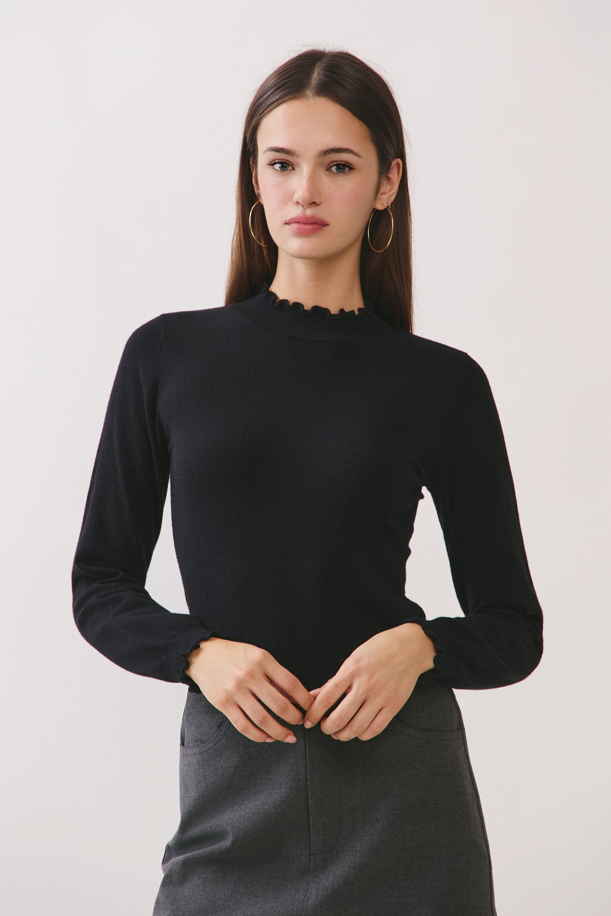 BTTRMMT Suri Ruffle Neck Knit Top front view with fitted silhouette and ruffle neckline