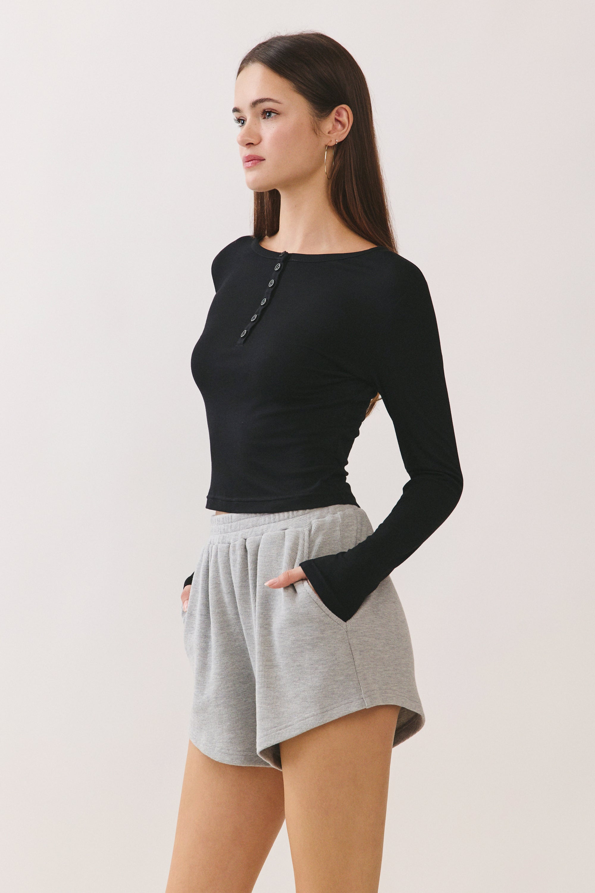 BTTRMMT Black Aubree Henley Top side view showing slim fit, long sleeves, and smooth stretch fabric.