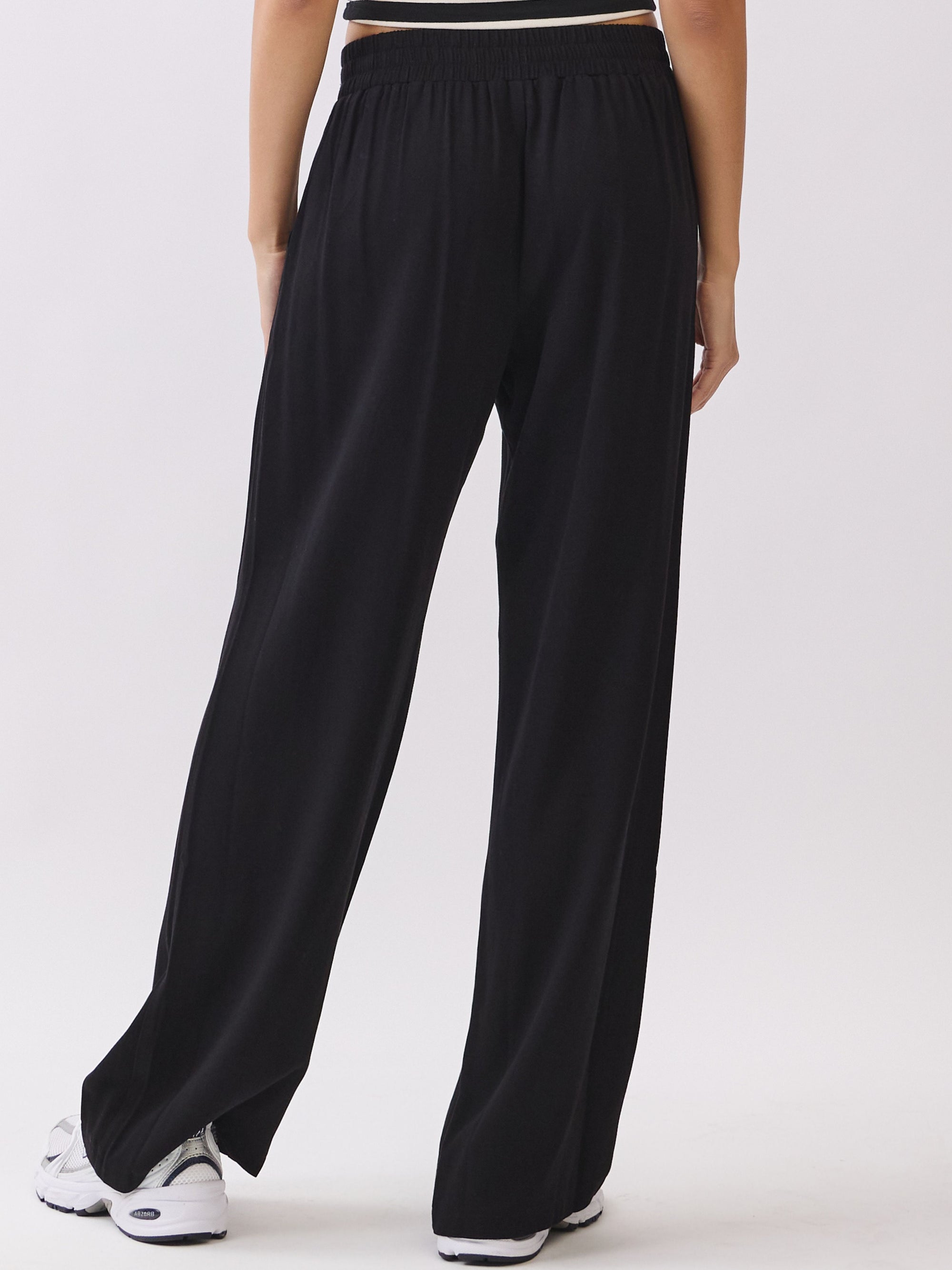 Back view of BTTRMMT Black Yuna Soft Wide Leg Pants featuring a relaxed drape, drawstring waistband, and soft flowy silhouette.