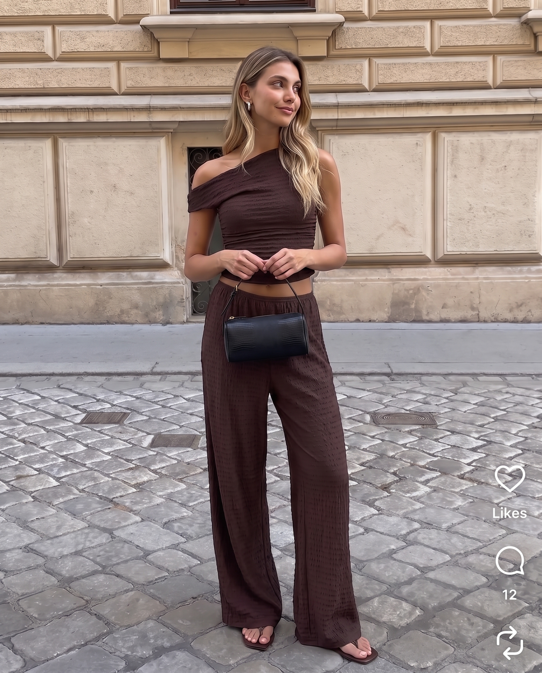 Model wearing the BTTRMMT Daniela Off-Duty Set in brown, featuring a one-shoulder ruched top and matching wide-leg pants for an elevated casual look.
