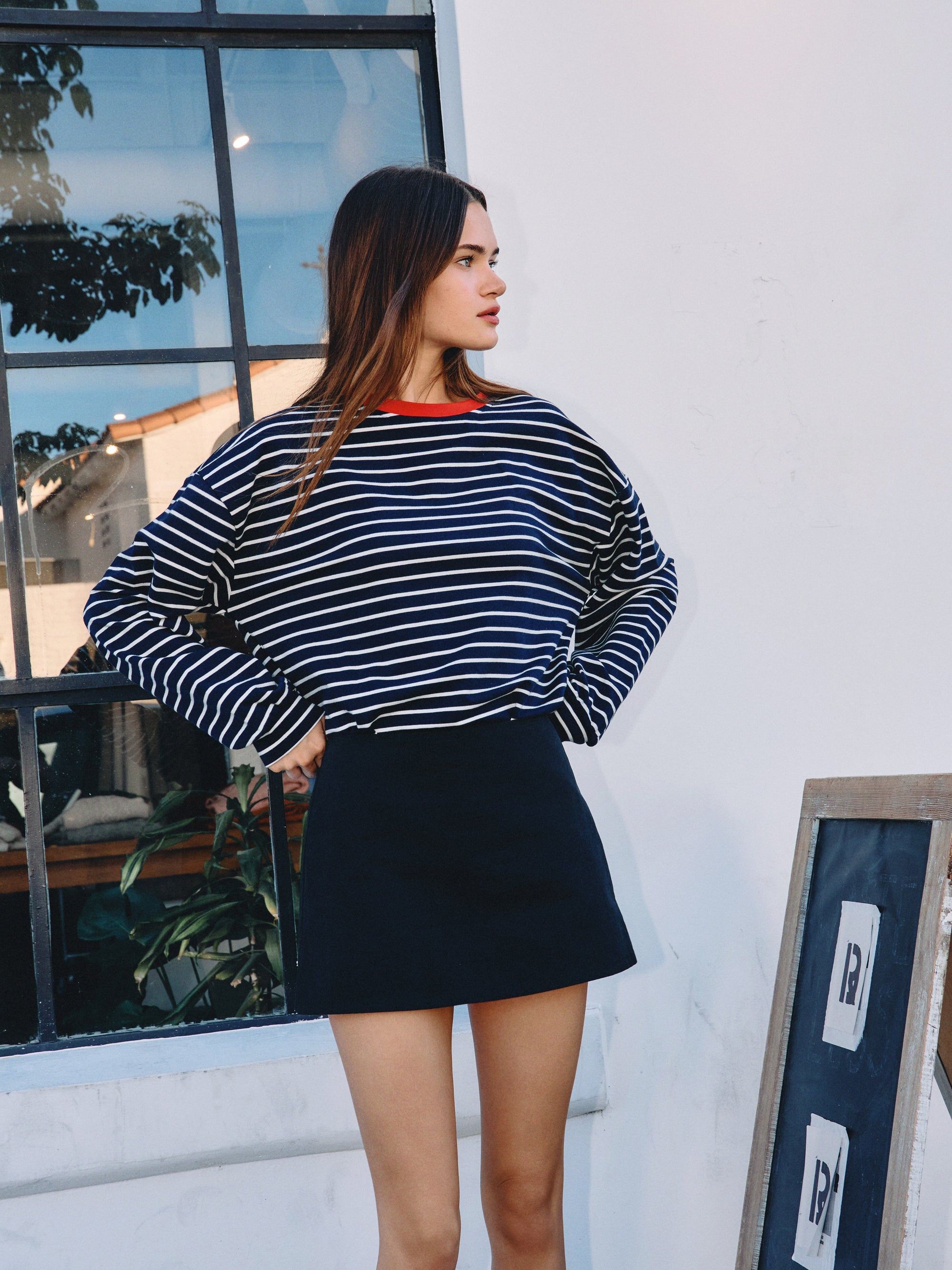 BTTRMMT Gia Essential Skort front view with clean mini silhouette paired with Striped long sleeve shirt.