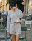 Model wearing the BTTRMMT Gray Sweet Easy Sweatshirt featuring a soft cropped fit, relaxed long sleeves, and cozy lightweight fabric.