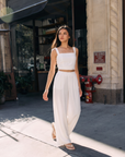 Model wearing BTTRMMT Ivory Olivyn Set featuring a cropped square-neck top and matching high-waisted wide-leg pants.