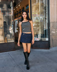 BTTRMMT Ivory and Black Striped Ribbed Tank Top – street style shot with denim mini skirt and tall black boots.