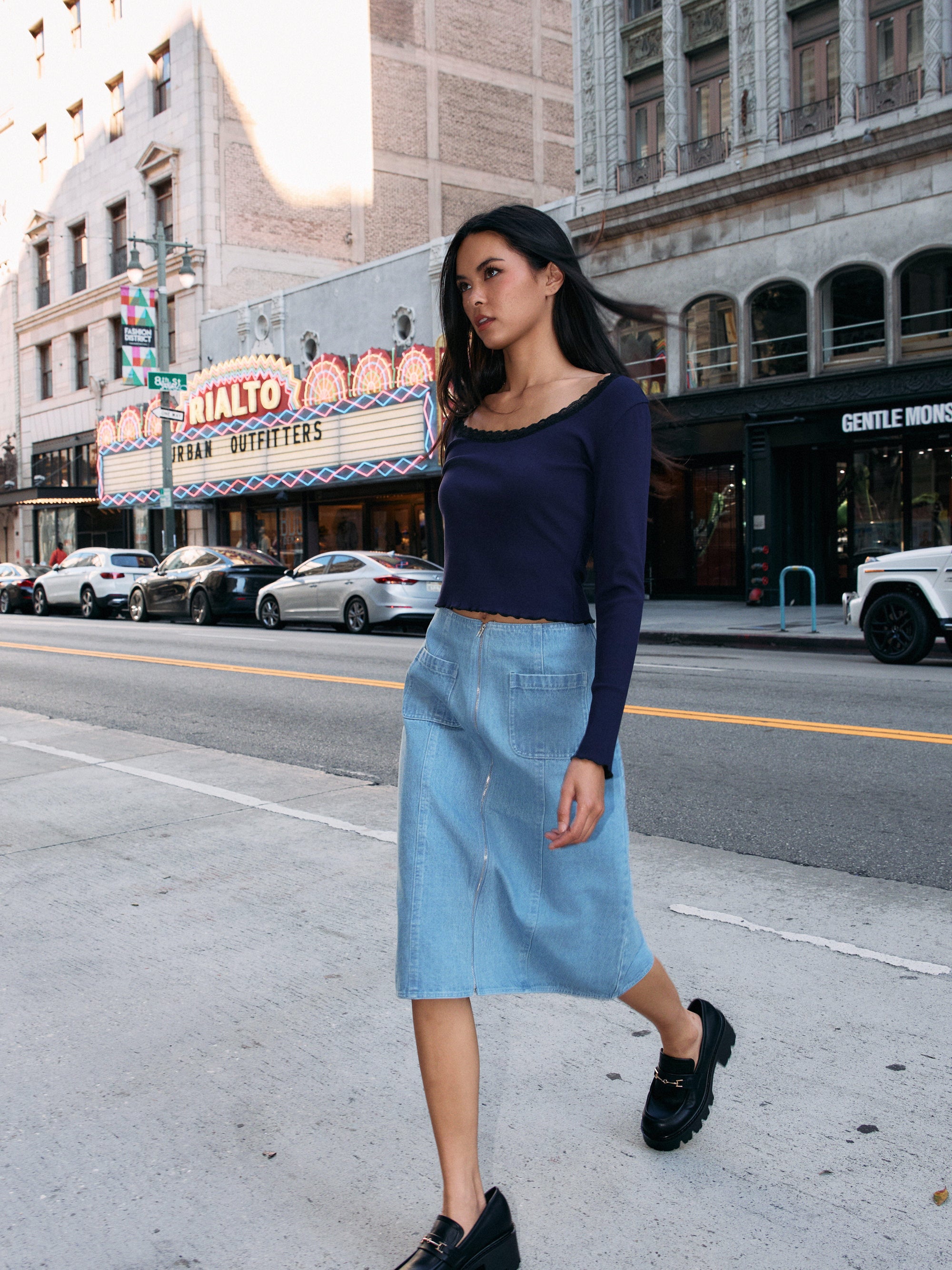 Model wearing BTTRMMT Fiona Denim Midi Skirt with front pockets and a straight mid-length fit, styled for an everyday street look.