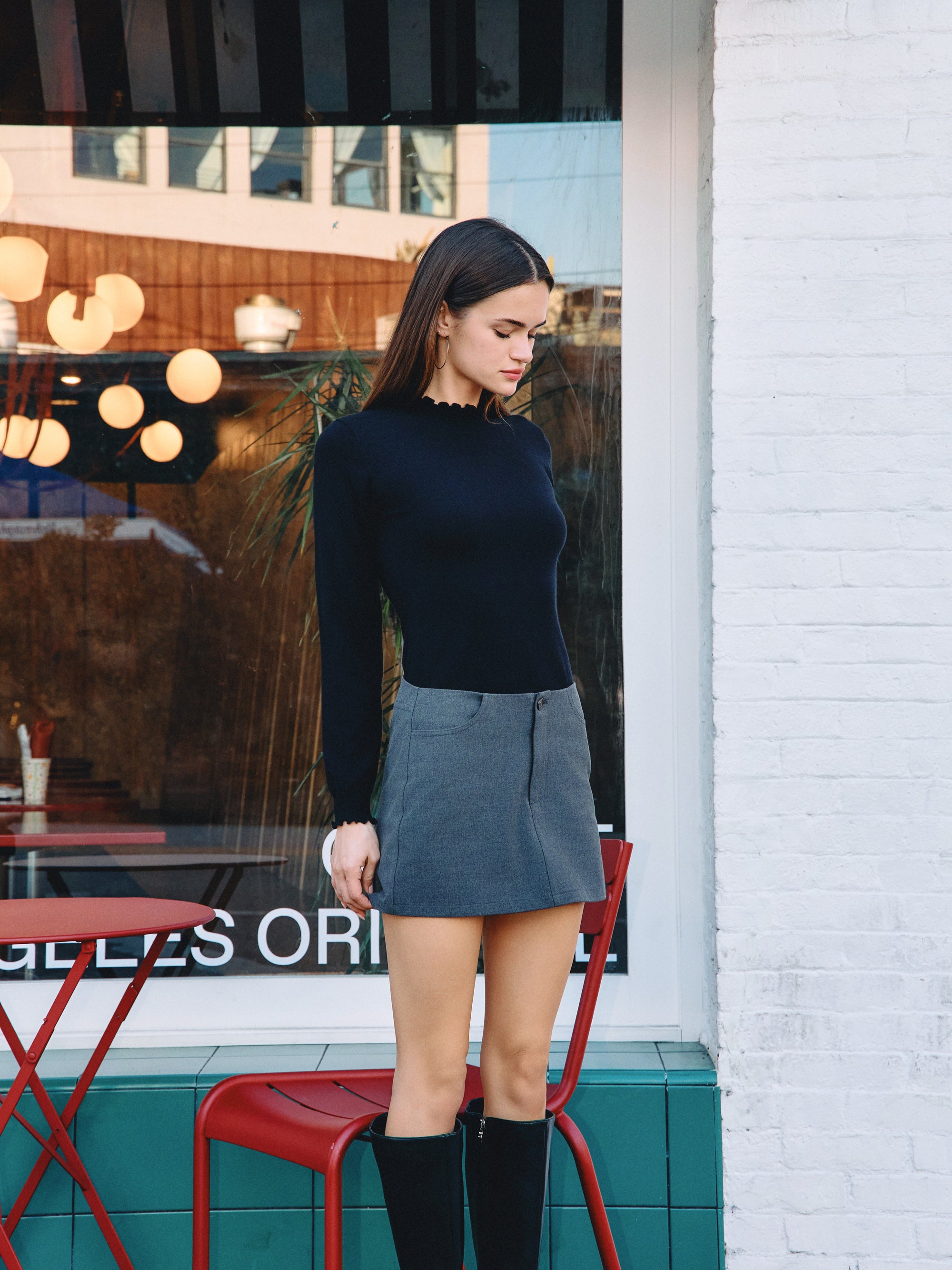 BTTRMMT Suri Ruffle Neck Knit Top styled on model in downtown Los Angeles street