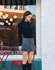 BTTRMMT Suri Ruffle Neck Knit Top styled on model in downtown Los Angeles street