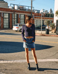BTTRMMT Tate Everyday Denim Skirt lifestyle shot styled in downtown Los Angeles street setting