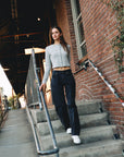 BTTRMMT Evie Mid-rise Washed Black Denim Jeans with relaxed straight-leg fit styled casually outdoors