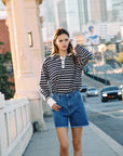 BTTRMMT Sloan Striped Long Sleeve Polo styled casually with denim in downtown Los Angeles street setting