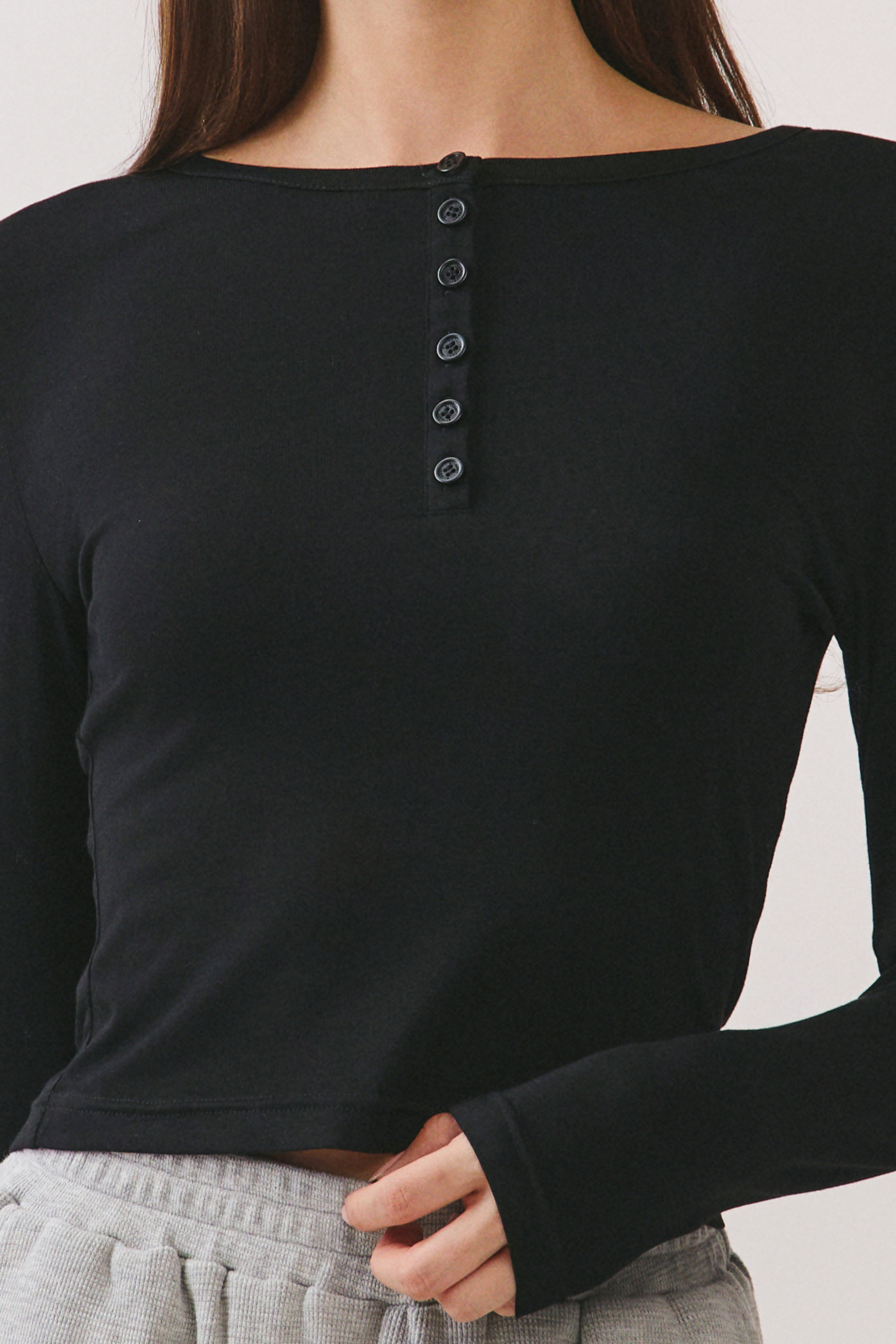 BTTRMMT Black Aubree Henley Top close-up showing button placket detail and soft ribbed fabric texture.