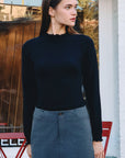 BTTRMMT Suri Ruffle Neck Knit Top styled on model in downtown Los Angeles street