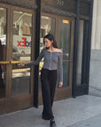 Video clip of BTTRMMT model walking outside in the Camille Zip Knit, styled with black wide-leg pants and loafer.